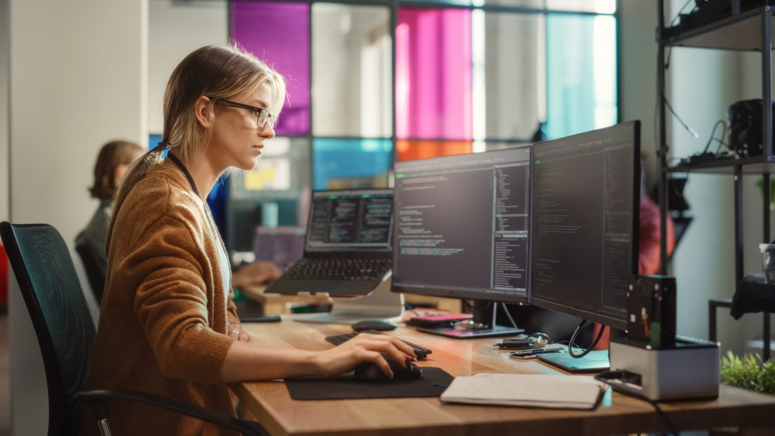 Caucasian,Woman,Coding,On,Desktop,Pc,And,Laptop,Setup,With