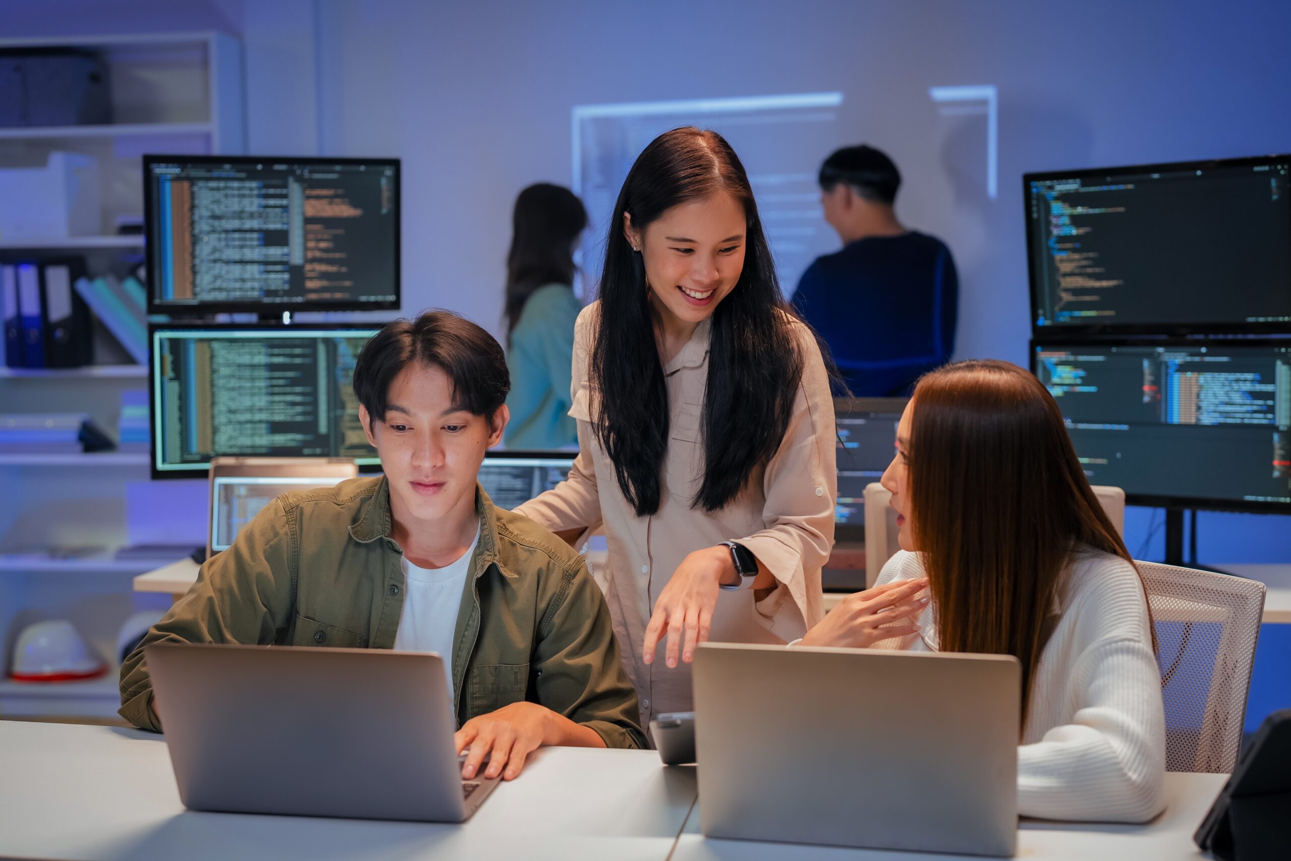 Asian,Programmers,Collaborating,On,Software,Development,At,Night,,Focused,On